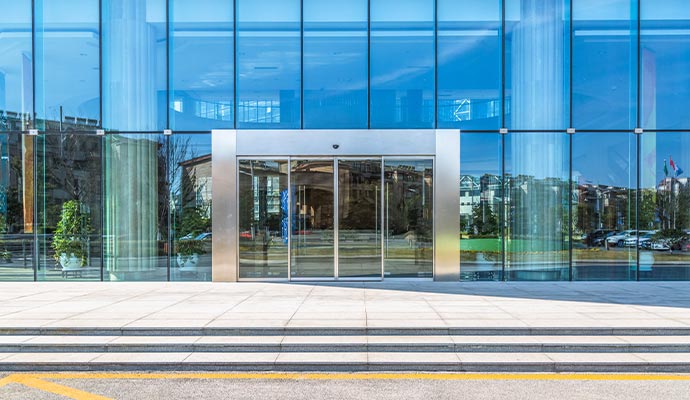 Entrance to a modern commercial glass building. Entrance to a modern commercial glass building.